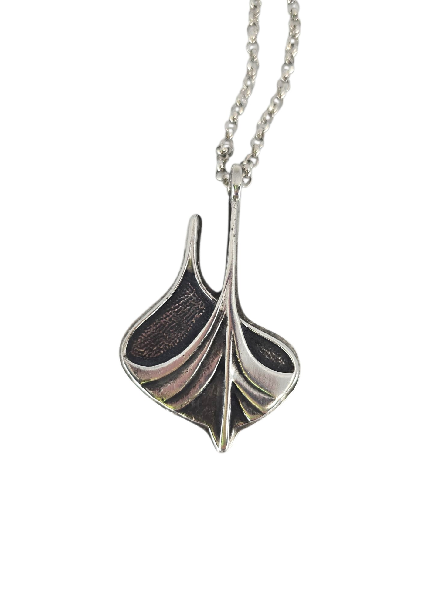 A Norwegian-crafted necklace features a Viking ship pendant in pewter and sterling silver on a 24" chain (2" × 1.25"), blending textured and smooth surfaces for a modern take on sterling silver jewelry.