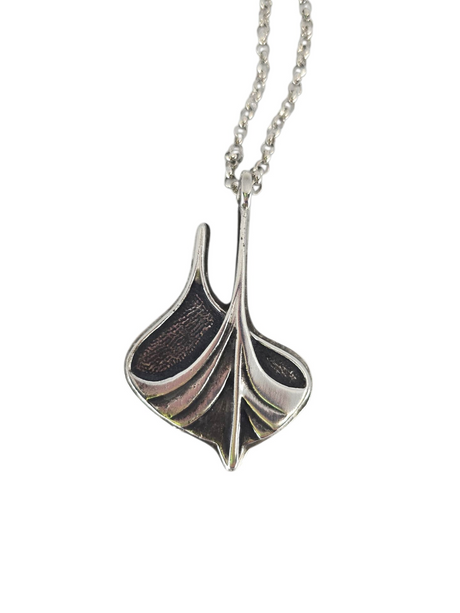 A Norwegian-crafted necklace features a Viking ship pendant in pewter and sterling silver on a 24" chain (2" × 1.25"), blending textured and smooth surfaces for a modern take on sterling silver jewelry.