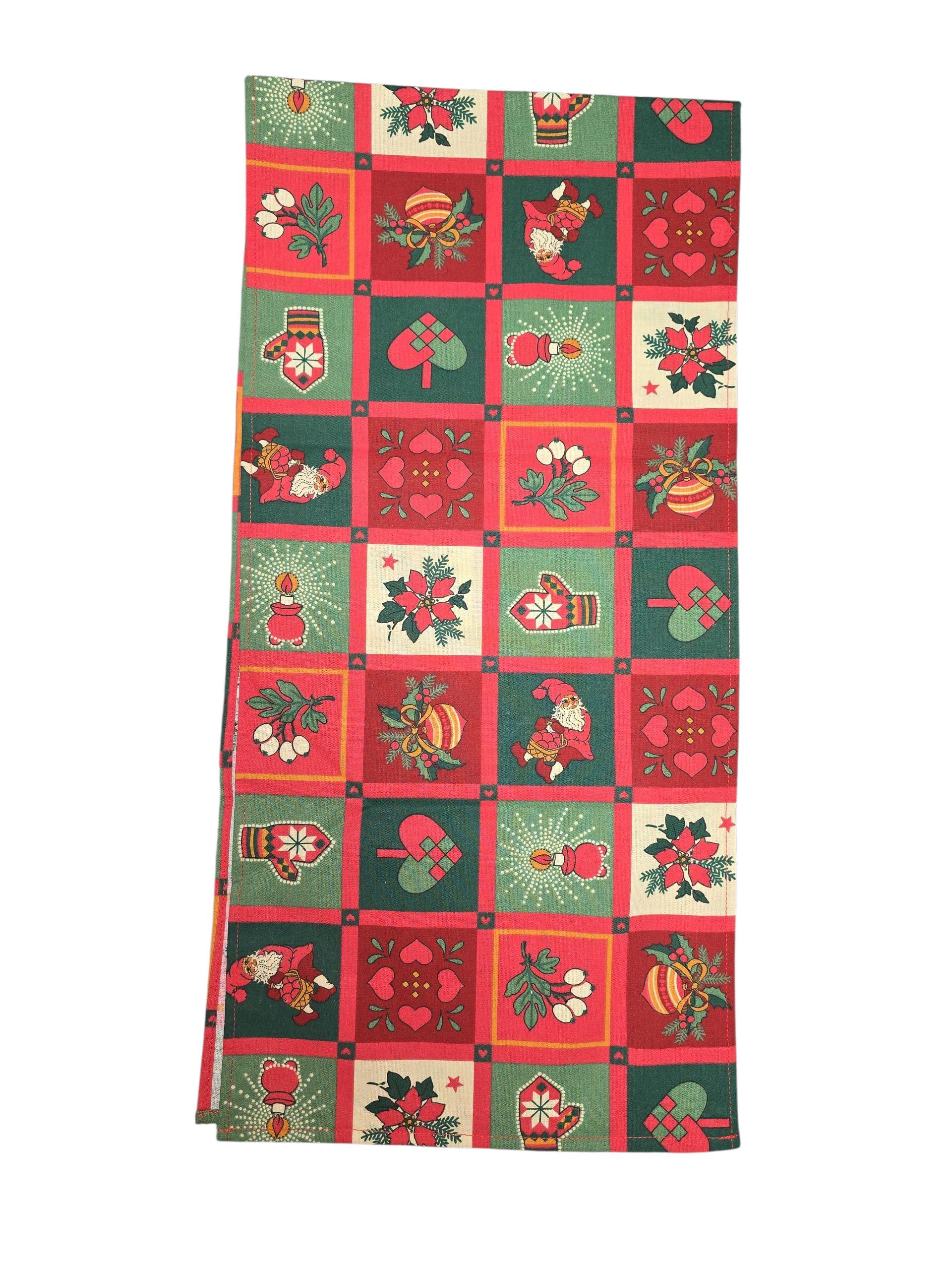 The Runner: Scandinavian Christmas Table Runner 48" Long features a red, green, and cream checkered Swedish fabric with Santa, ornaments, hearts, bells, and holly—perfect festive decor for your holiday table.