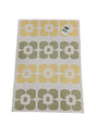 The Horredsmattan Florian vinyl rug features a rectangular shape with a yellow and green geometric flower pattern on a white background, plus a top right tag.