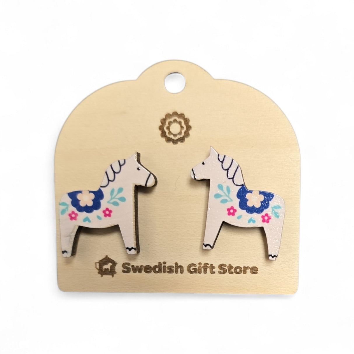White Dala Horse stud earrings with colorful kurbits designs rest on a light card labeled Swedish Gift Store—perfect handcrafted Nordic accessories to add to your collection.