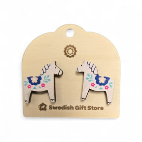 White Dala Horse stud earrings with colorful kurbits designs rest on a light card labeled Swedish Gift Store—perfect handcrafted Nordic accessories to add to your collection.