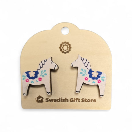 White Dala Horse stud earrings with colorful kurbits designs rest on a light card labeled Swedish Gift Store—perfect handcrafted Nordic accessories to add to your collection.
