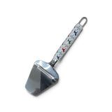 Stainless steel cheese slicer with a white handle featuring Swedish Dala horse patterns and floral motifs.