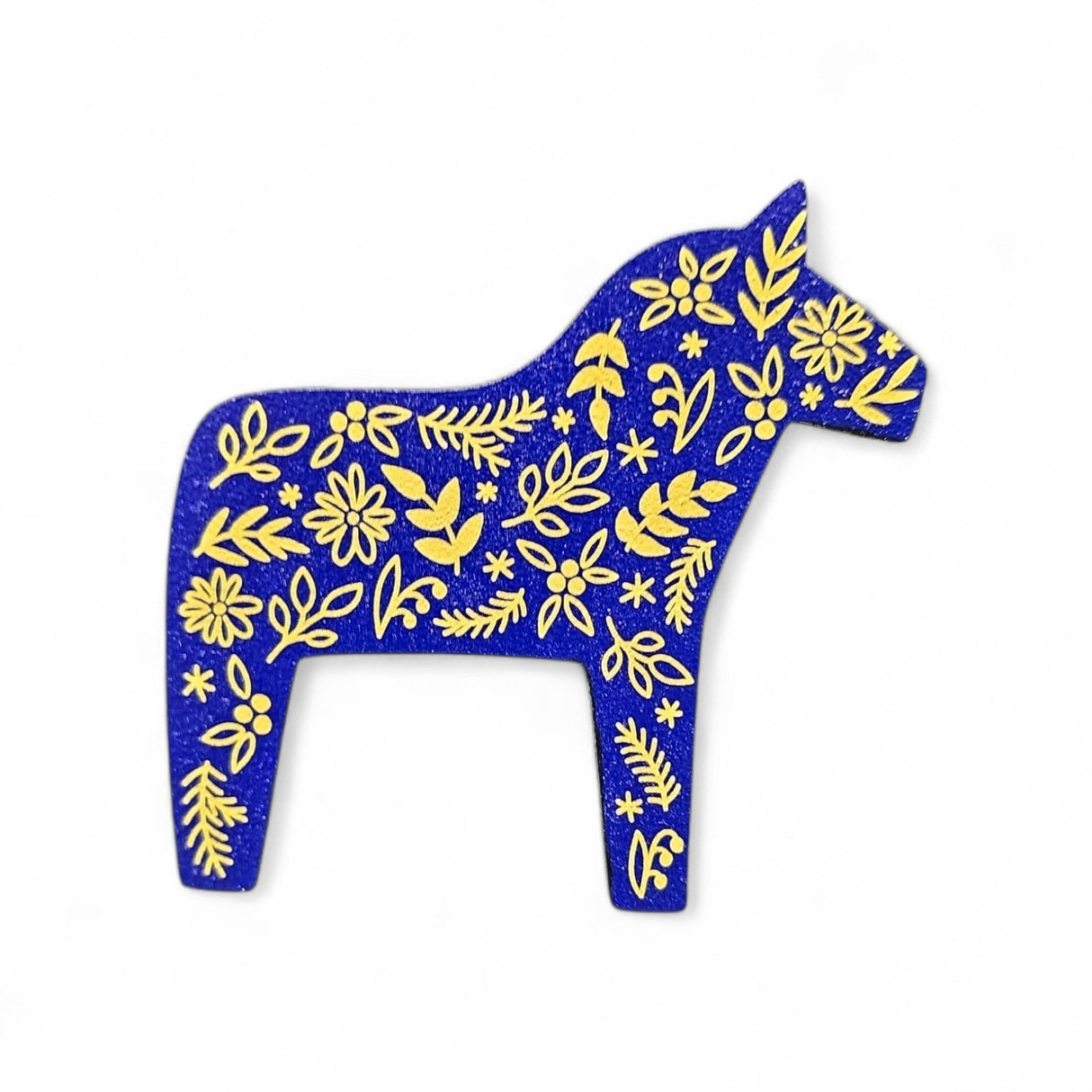 The Magnet: Blue Swedish Dala Horse with Yellow Kurbits Refrigerator Magnet is a charming Minnesota souvenir, handcrafted from wood and featuring traditional yellow kurbits designs on a blue background.