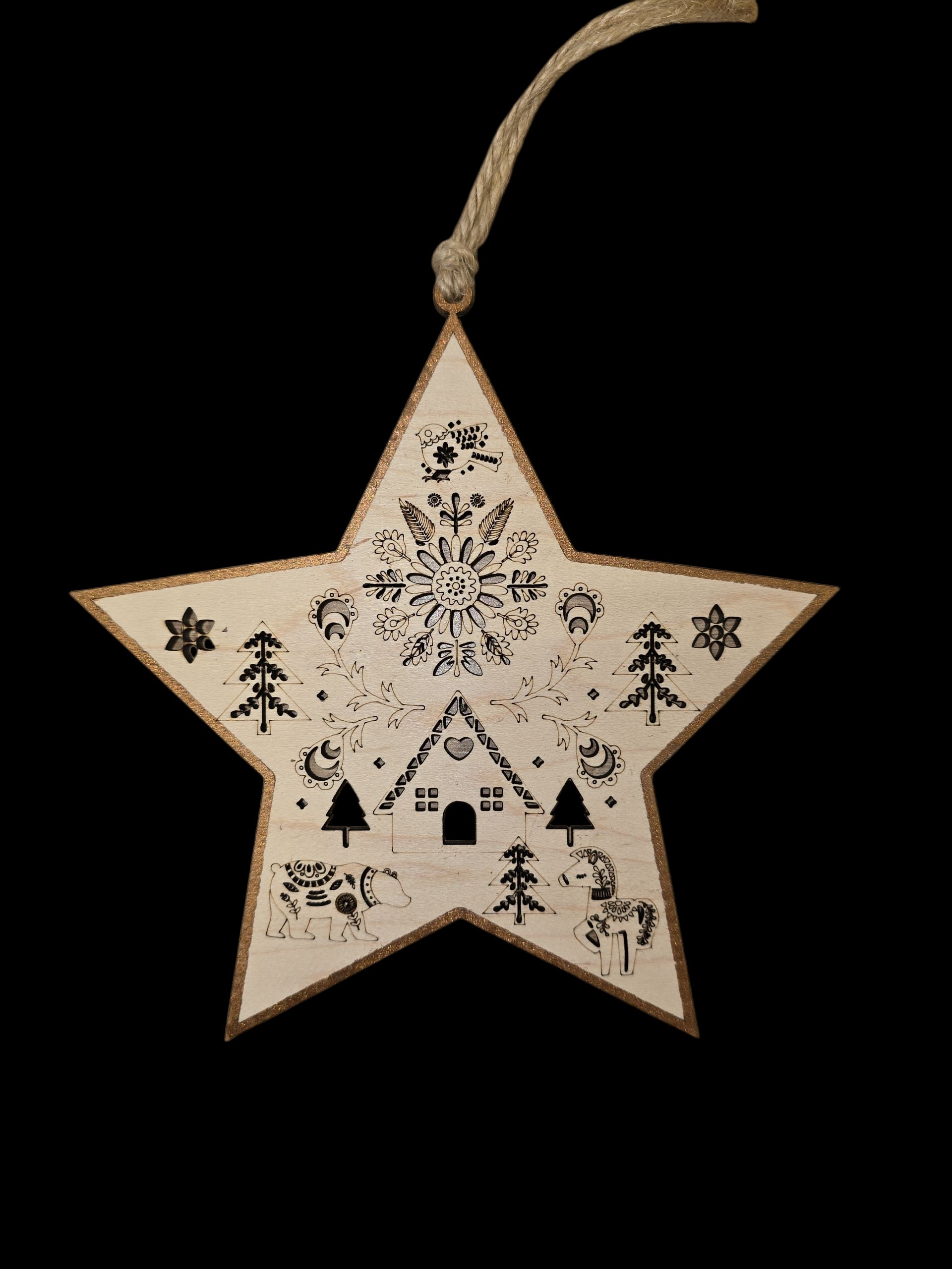The Ornament: Swedish Laser Cut Star is a 6"x6" birch wood Christmas tree ornament featuring black folk art designs like a Dala horse, house, trees, and pig. It hangs by a twine loop and is crafted in Swedish style.