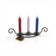 A Talla Imports Danish Iron Viking Ship Candle Holder for 3 taper candles displays red, white, and blue partially melted candles on a white background with a yellow "Danish Iron" tag attached to the Scandinavian holder.
