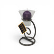 A Talla Imports Candle Holder: Danish Iron with Tall Curl Base holds a purple ball candle in a Leif Cup. The stand features a tag reading "Danish Iron" and is set against a plain white background.