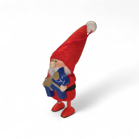 A small Scandinavian figurine named "Red Santa with Blue Dala Horse" features a gnome in a red outfit holding a blue Dala horse, set against a plain white background.