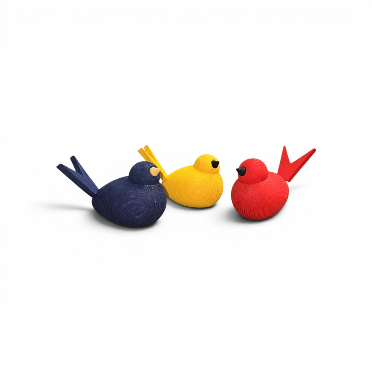 Three 3" handcrafted wooden Scandi bird figurines by Bergquist Imports sit together on a white background in blue, yellow, and red.
