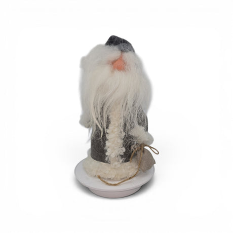 The "Tomte with Robe" and Burlap Bag gnome figurine by Gumselids of Sweden, offered by Talla Imports, stands 12 inches tall on a wood base. Inspired by Scandinavian folklore decor, it features a long white beard, a grey hat, a fur-trimmed coat, and rests against a plain white background.