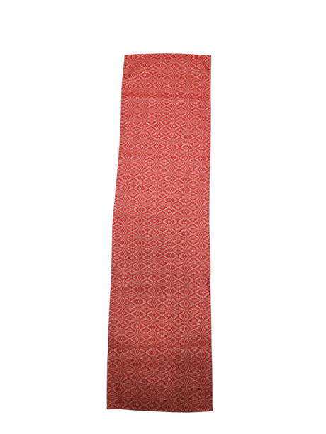 A "Norrland" reddish orange table runner with silver ice star patterns, measuring 48" long, displayed flat on a white background.
