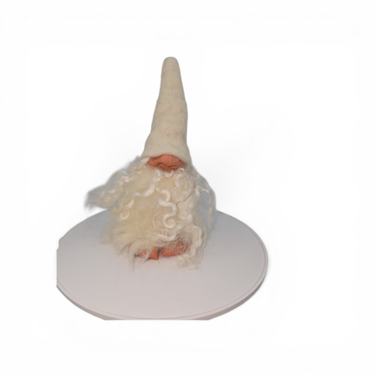 A "Foot Tomte" gnome figurine by Talla Imports, handcrafted by Gumselids of Sweden, featuring a tall white hat, long curly white beard, clay nose and feet, stands on a white circular platform against a plain white background. The gnome measures 6 inches to the tip of its hat.