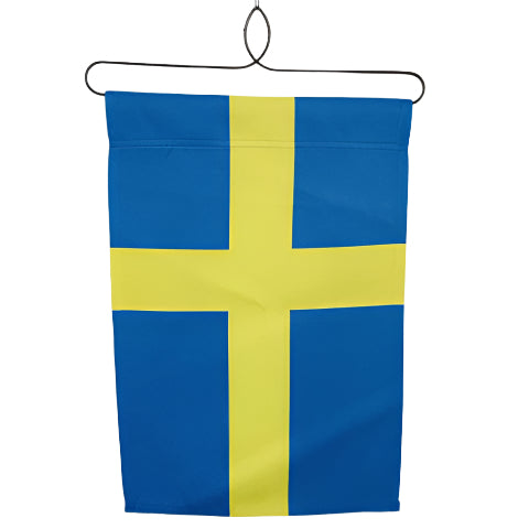 The Flag: Sweden Garden Flag 12 x 18 features a yellow Nordic cross on a blue, weather-resistant polyester background and hangs from a black wire hanger against a white wall.