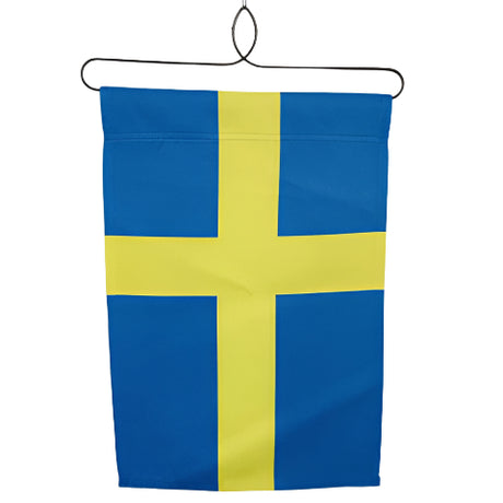 The Flag: Sweden Garden Flag 12 x 18 features a yellow Nordic cross on a blue, weather-resistant polyester background and hangs from a black wire hanger against a white wall.