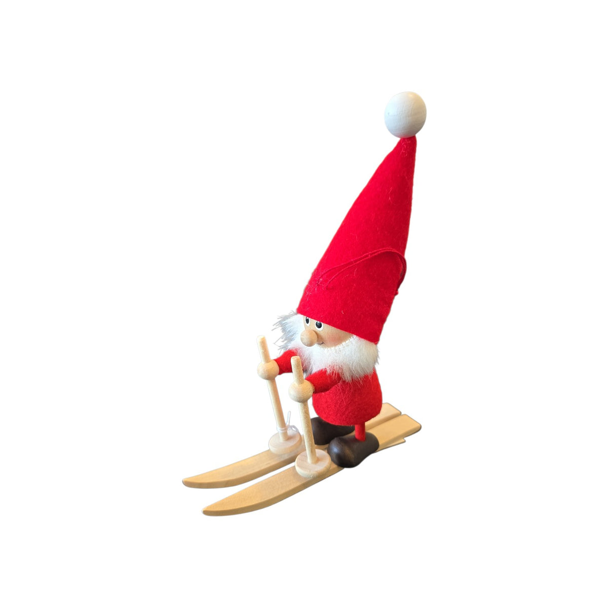 Scandinavian wooden tomte gnome figurine wearing a tall red hat and standing on wooden skis.