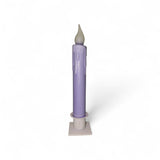 The Candle: Hand-Dipped Beeswax 7" Tapered LED Light is a battery operated timer candle that looks like a classic hand-dipped taper, featuring a white flame-shaped tip and molded wax drips.
