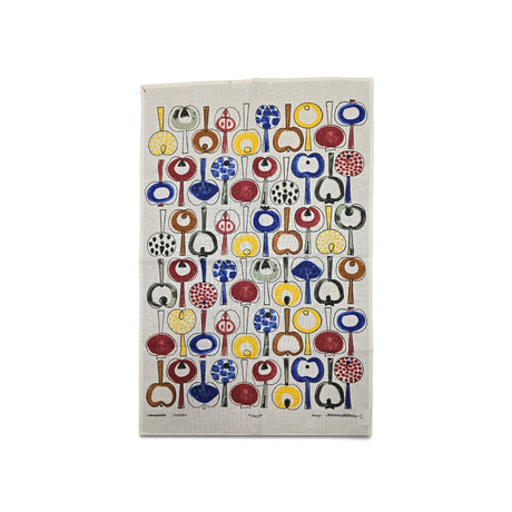 Tea towel with rows of red, yellow, blue, and black abstract shapes arranged in a grid on a light background.