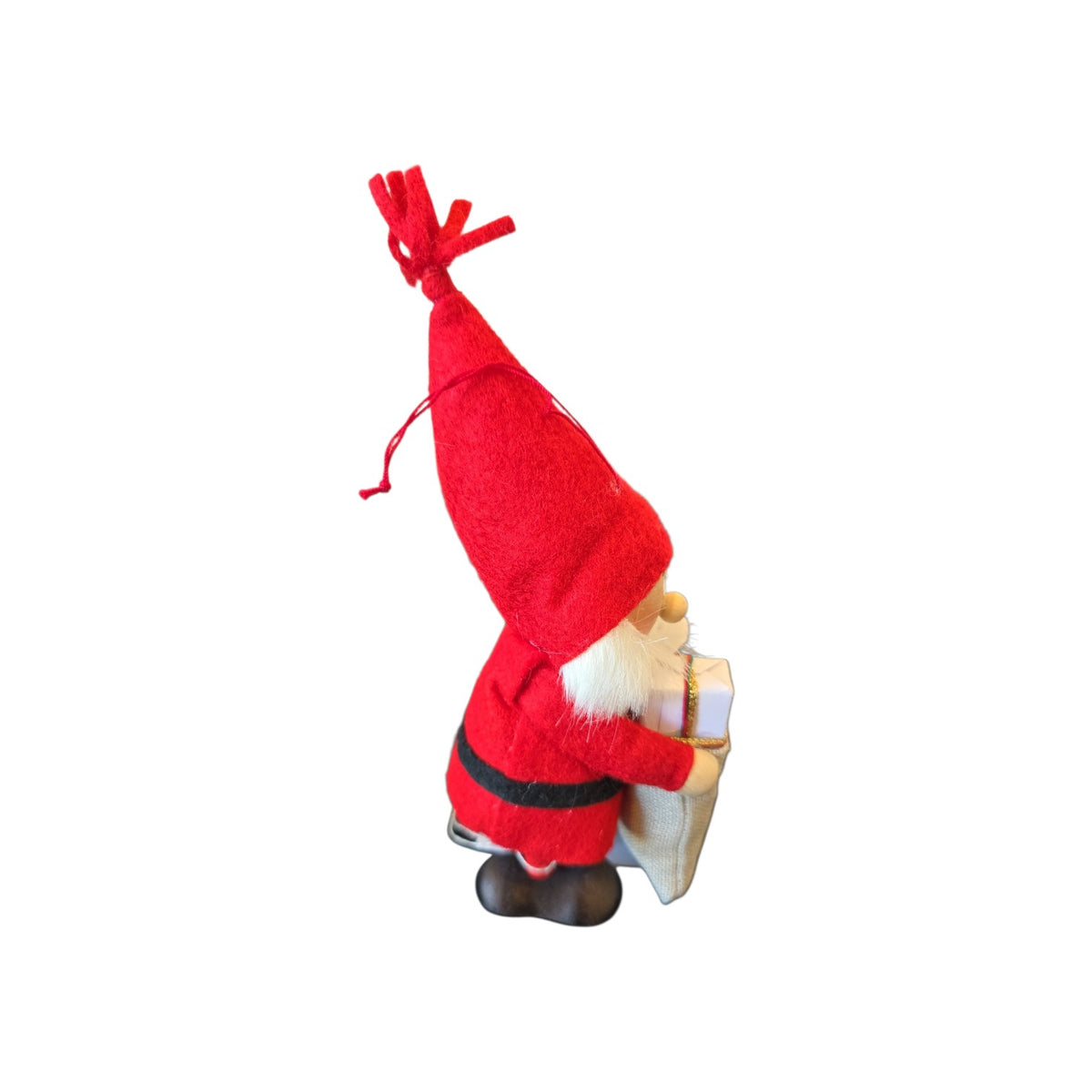 Felt gnome ornament wearing a tall red hat and black belt, holding a small gift package.