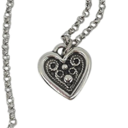The Necklace: Heart Shaped Pewter Pendant & Stainless-Steel Chain by Hillestad of Norway features a pewter heart with raised dot and swirl designs on a dark background, inspired by elegant Scandinavian jewelry artistry.