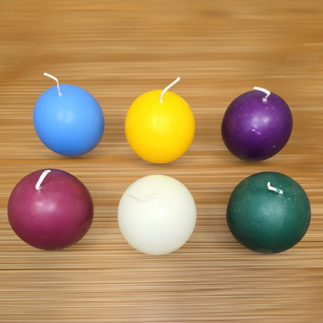 A four-pack of Logum Kloster Lys 2.5" ball candles from Denmark in assorted colors adds a vibrant Scandinavian touch to your décor, perfect for display on any wooden surface.