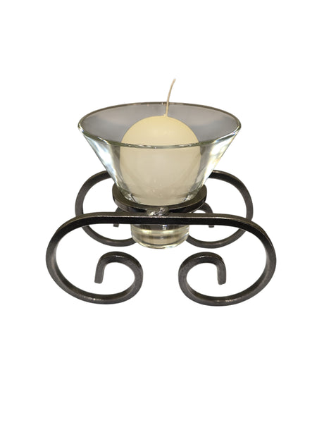 The Logum Kloster Lys 2.5" Ball Candles (4 Pack) feature round white candles in glass holders on a black metal stand with decorative scrollwork—ideal for bringing classic Scandinavian style to your home.