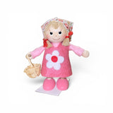 The Figurine: Scandinavian Tomte Girl in Pink by Faire - Nordic Dreams features a charming gnome with blonde hair, a floral headscarf, pink dress and shoes, holding a woven basket—an ideal accent for Nordic-inspired decor. Made in Scandinavia.