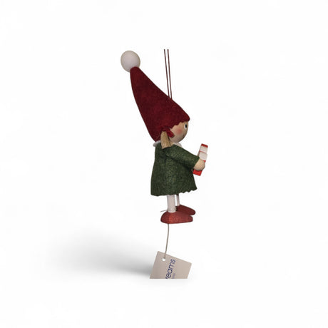 A small handcrafted Scandinavian Girl figurine holding a Dala Horse, featuring a red hat, green coat, and red shoes, suspended by a string with an attached tag.
