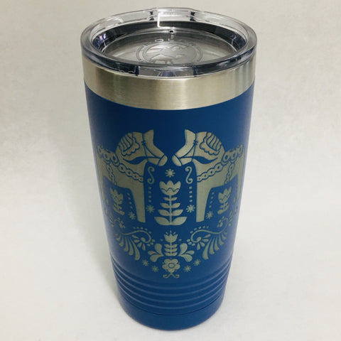 The "Tumbler: Dala Horses on Royal Blue" features a stainless steel build with a silver lid and is adorned with decorative horse and floral designs, capturing the essence of Polar Camel Tumblers.