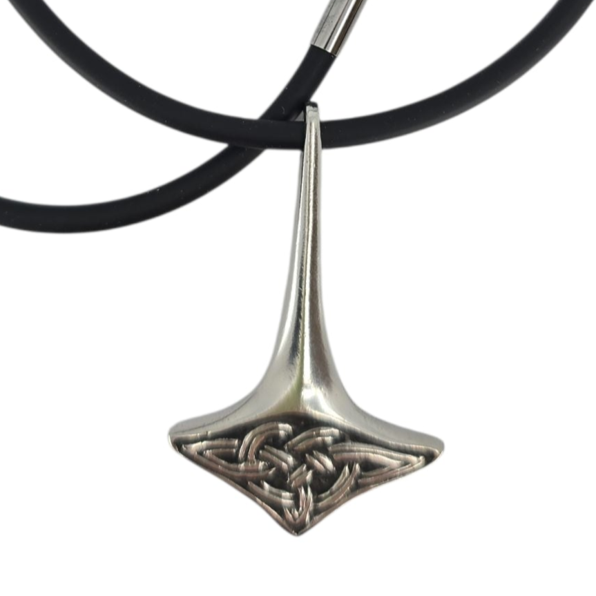 A pewter Thor’s Hammer pendant inspired by Norse mythology hangs from a black rubber chain. Necklace: Thor’s Hammer Pewter Pendant with Black Rubber Chain – Hillestad of Norway.