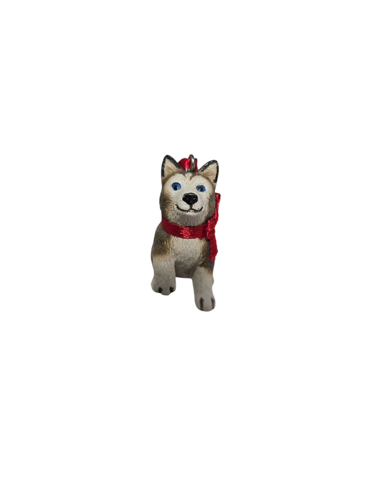 Charming 1.75" Ornament: Birki - Anja's Husky Puppy from The Wish Books, featuring a small dog figurine with a red scarf standing upright on a white background for festive flair.