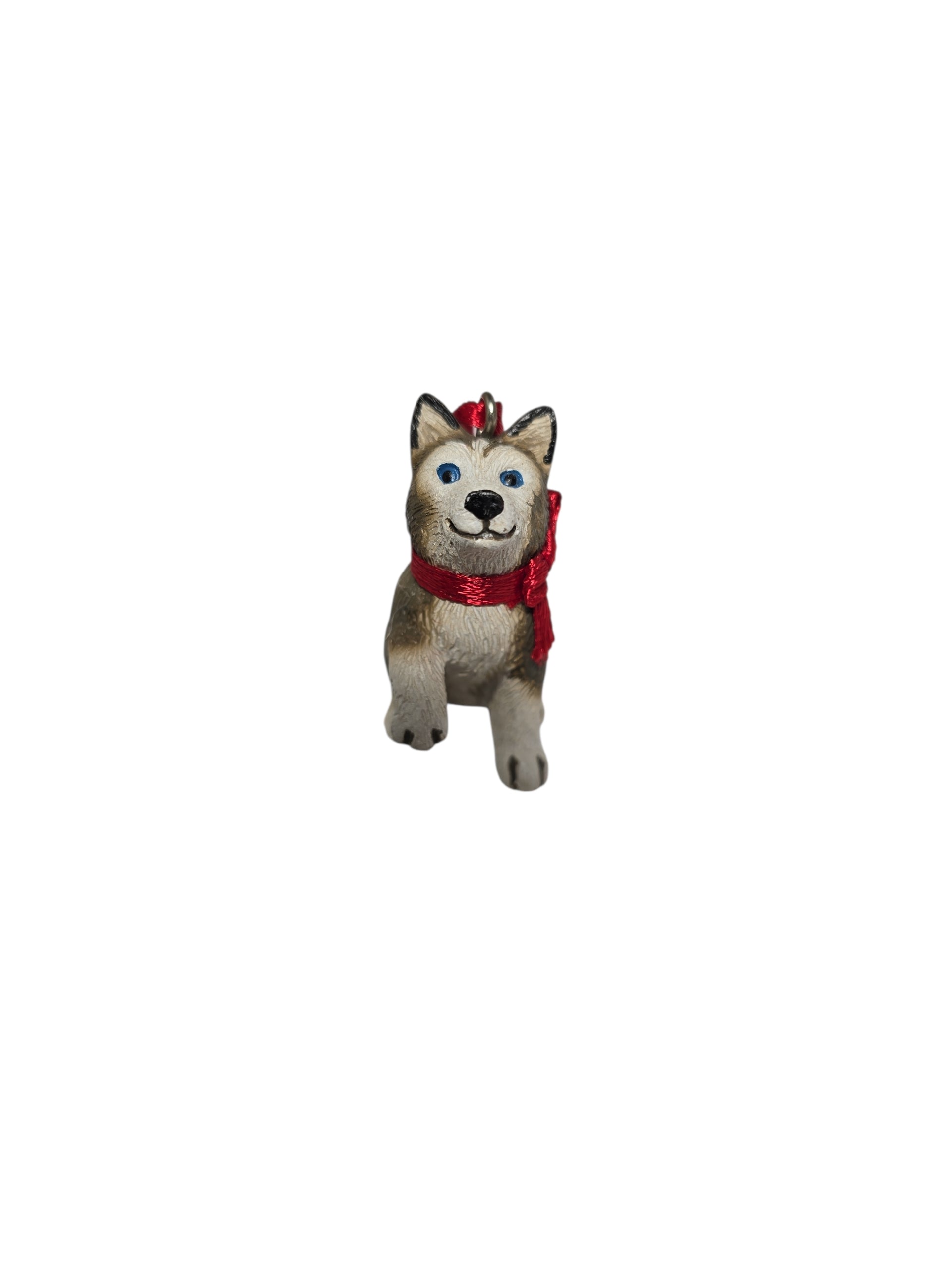 Charming 1.75" Ornament: Birki - Anja's Husky Puppy from The Wish Books, featuring a small dog figurine with a red scarf standing upright on a white background for festive flair.