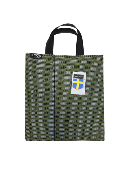 The Horredsmattan Floow Vinyl Bag (32x40cm) features green textured woven vinyl, black handles, a FLOOW label top left, and a Swedish flag tag—crafted from eco-friendly PVC inspired by classic Swedish rugs.