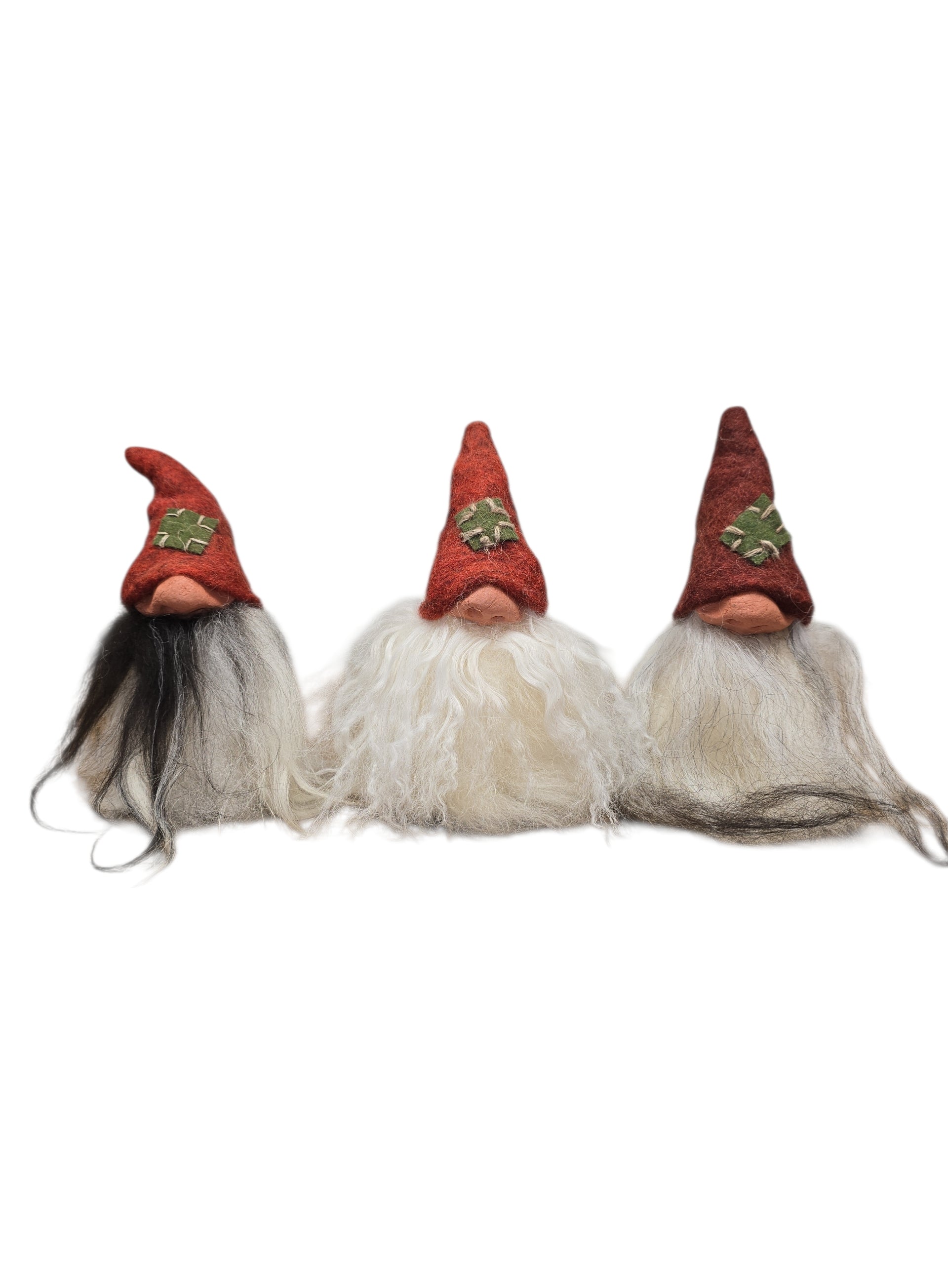 The "Patch Tomte" Gnome by Gumselids of Sweden stands 7" tall with a red hat and long multicolored beard, handcrafted and set on a wood base—perfect Scandinavian sheep wool decor for your home.