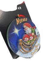 Celebrate Christmas with the “Norway” Santa with Elves on Sleigh 3D painted resin ornament (3" diameter)—a festive Scandinavian decoration featuring a Norwegian Santa and elves, perfect for your holiday tree!.