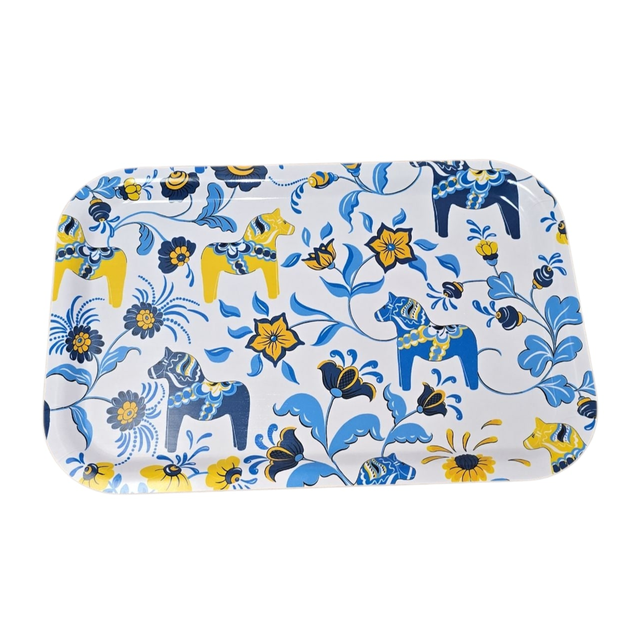 The Leksand Dala Horse Tray is a rectangular laminated birch wood tray (33 × 21 cm) featuring a white base with orange, red, and blue floral patterns and stylized horses inspired by Scandinavian design.