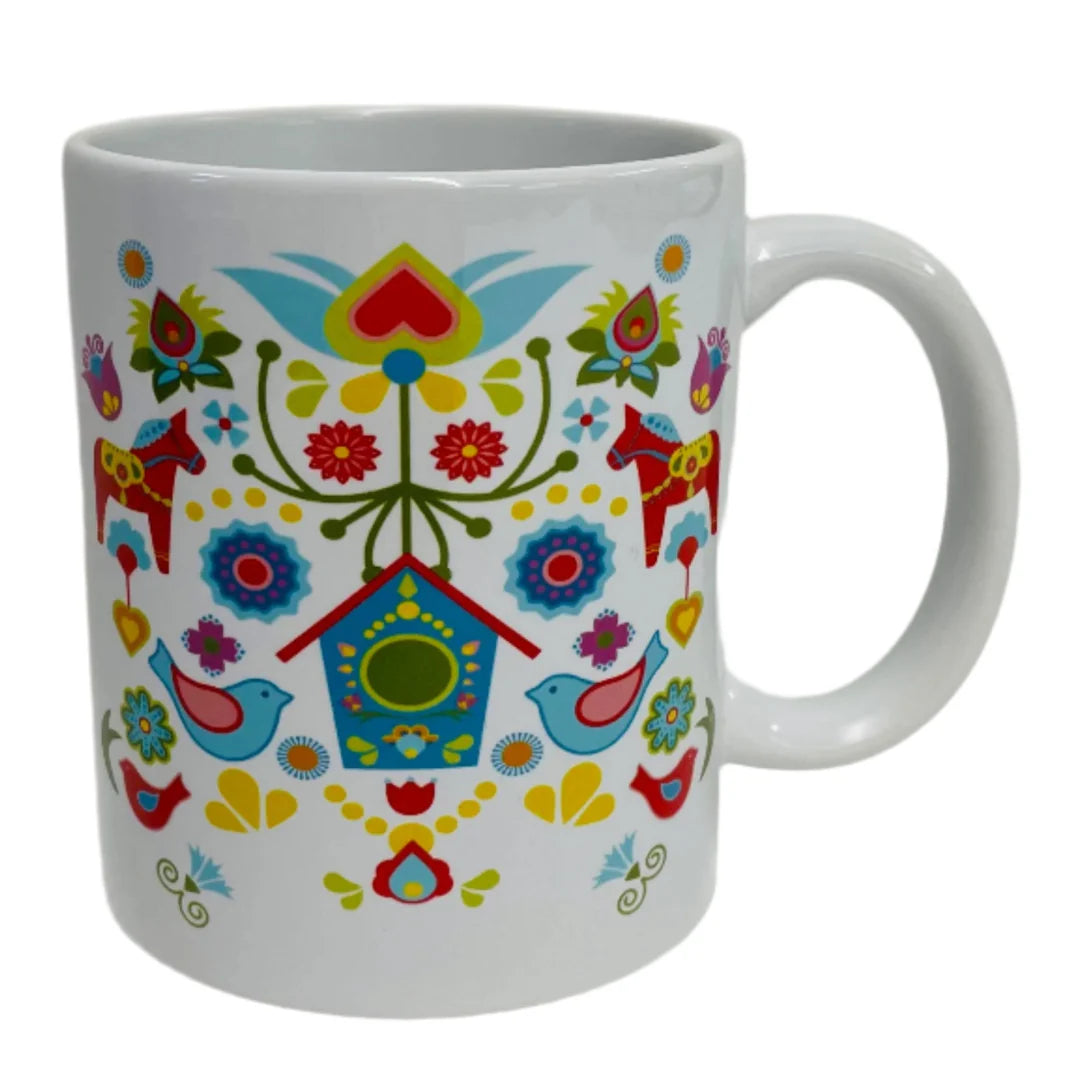 The Mug: Dala Horse with Bird House coffee mug features a charming Scandinavian-inspired design with birds, flowers, hearts, and a blue birdhouse, all inspired by Swedish Dala Horses and folk art.