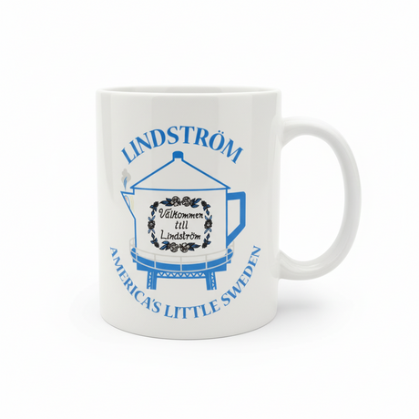 White 11oz mug featuring blue text and a coffee pot water tower illustration. Text reads: "Lindström, America’s Little Sweden" and "Välkommen till Lindström." A great Swedish heritage gift or Chisago Lakes souvenir.