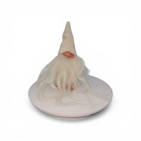 The "Foot Tomte" gnome figurine by Talla Imports, handcrafted by Gumselids of Sweden, features a tall white hat, long white beard, clay nose and feet, and sits on a round white platform against a plain white background.