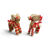 Two straw Dala horses and a Swedish Yule goat tied with red ribbon.