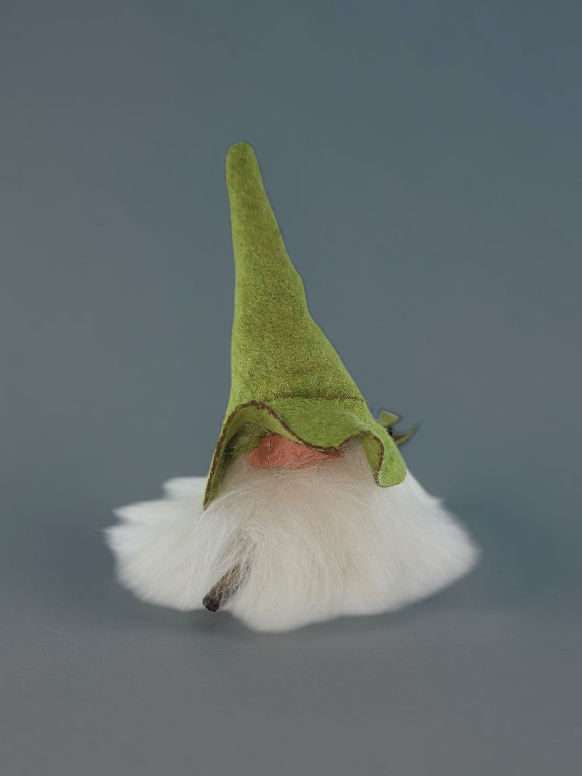 Tomte gnome ornament featuring a tall green felt hat and a long white beard.