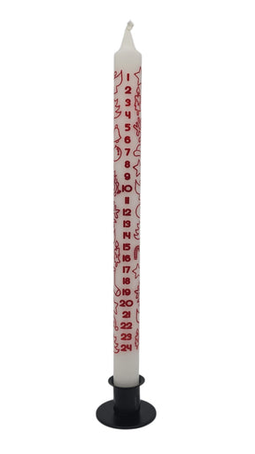 The Candle: Advent Taper Candle – White with Red Print (12" Tall) stands upright in a black holder, featuring red numbers 1 to 24 and festive designs—a stylish tribute to the Scandinavian Advent tradition.
