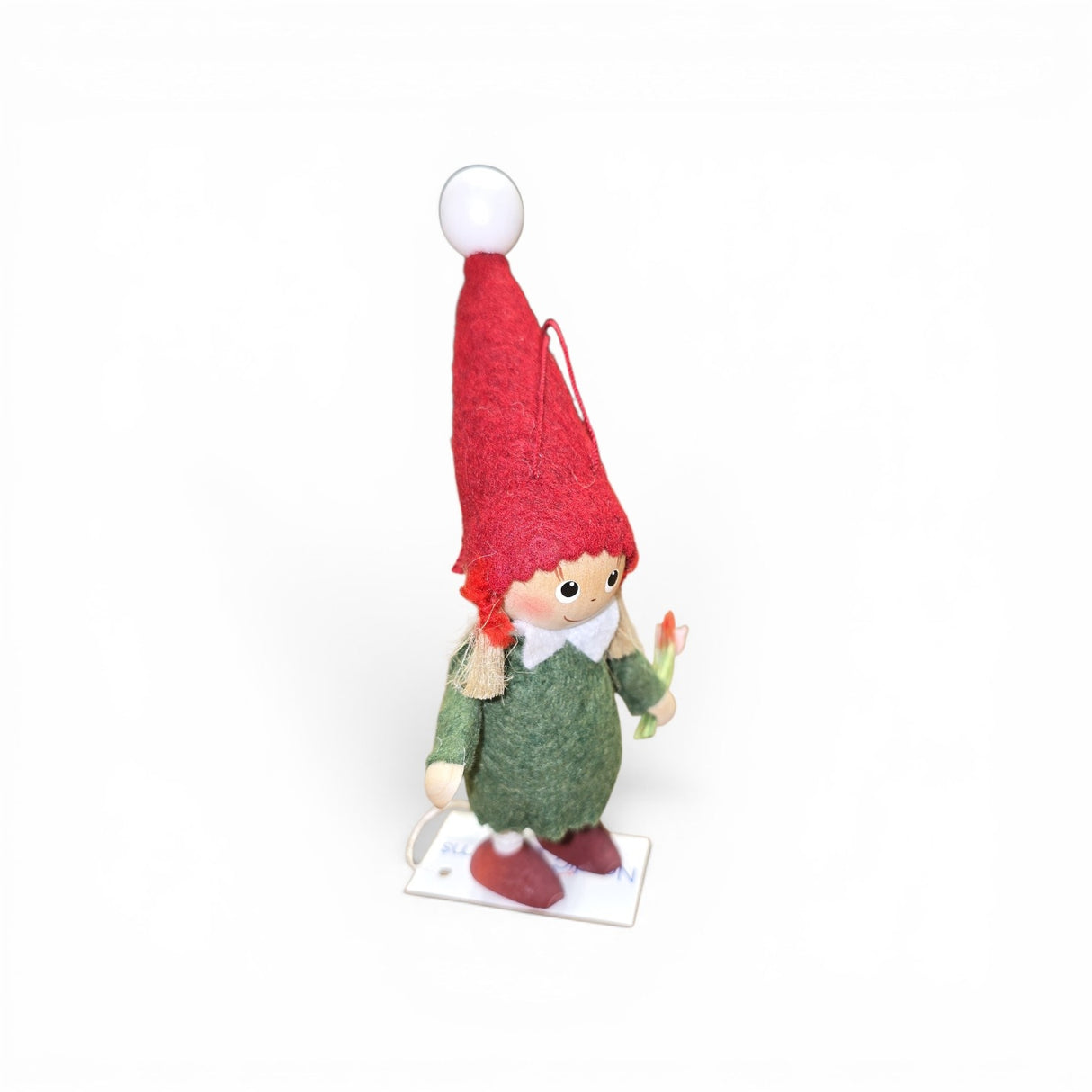 The Figurine: Scandinavian Girl Tomte by Faire - Nordic Dreams is a handcrafted gnome holding flowers, perfect as a Christmas decoration and inspired by Scandinavian tradition.