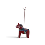 Red Dala horse ornament with colorful rosemaling patterns and a metal wire loop.