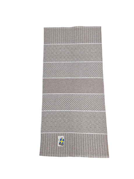 The Horredsmattan - Alfie - Heather vinyl rug is rectangular with alternating patterned and striped sections, plus a small Swedish flag tag in one corner, shown on a white background.