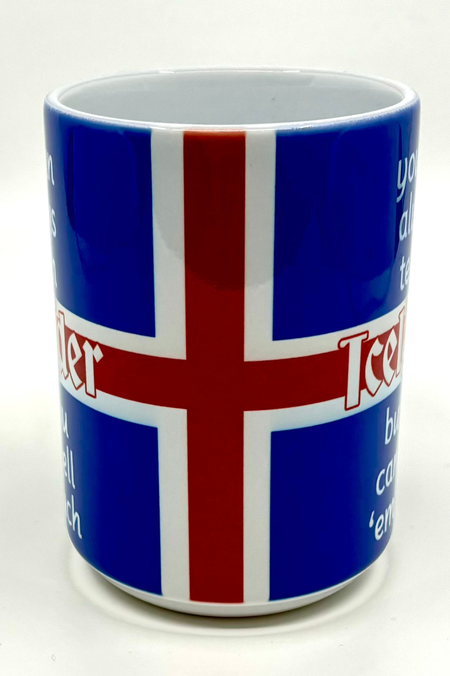 A 15 oz blue mug with a red and white Nordic cross design, adorned with the words "You Can Tell an Icelander" in matching colors around the pattern.