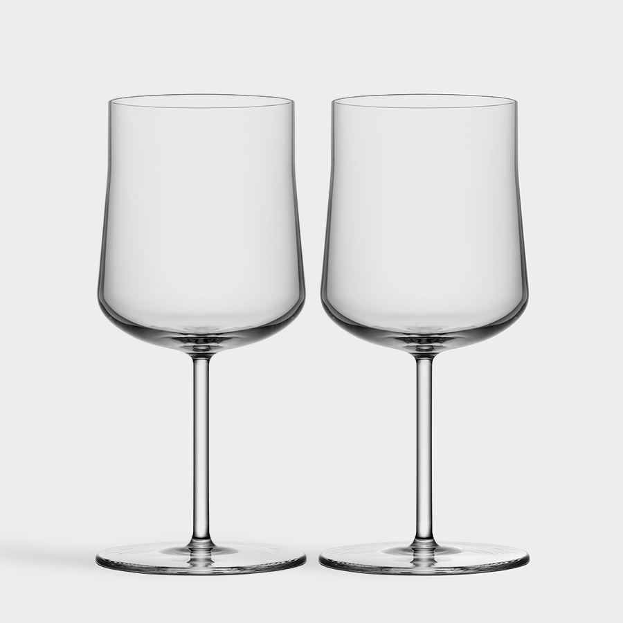 A pair of Orrefors Informal Medium Glasses (12oz) from the 2-Pack set stands elegantly with tall stems against a white background, embodying minimalist Scandinavian design.