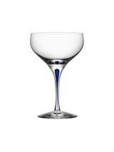 The Orrefors: Intermezzo Blue Coupe Glass 10oz by Erika Lagerbielke offers a clear glass bowl complemented by a stylish blue stem detail.