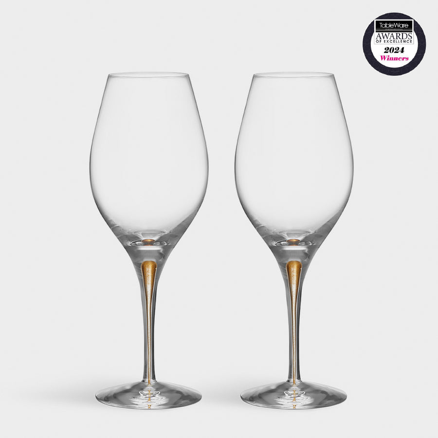 Two Orrefors: Intermezzo Gold Balance Glasses feature gold-detailed stems, set against a white background. The Tableware Awards 2024 Winner badge is in the upper right corner.