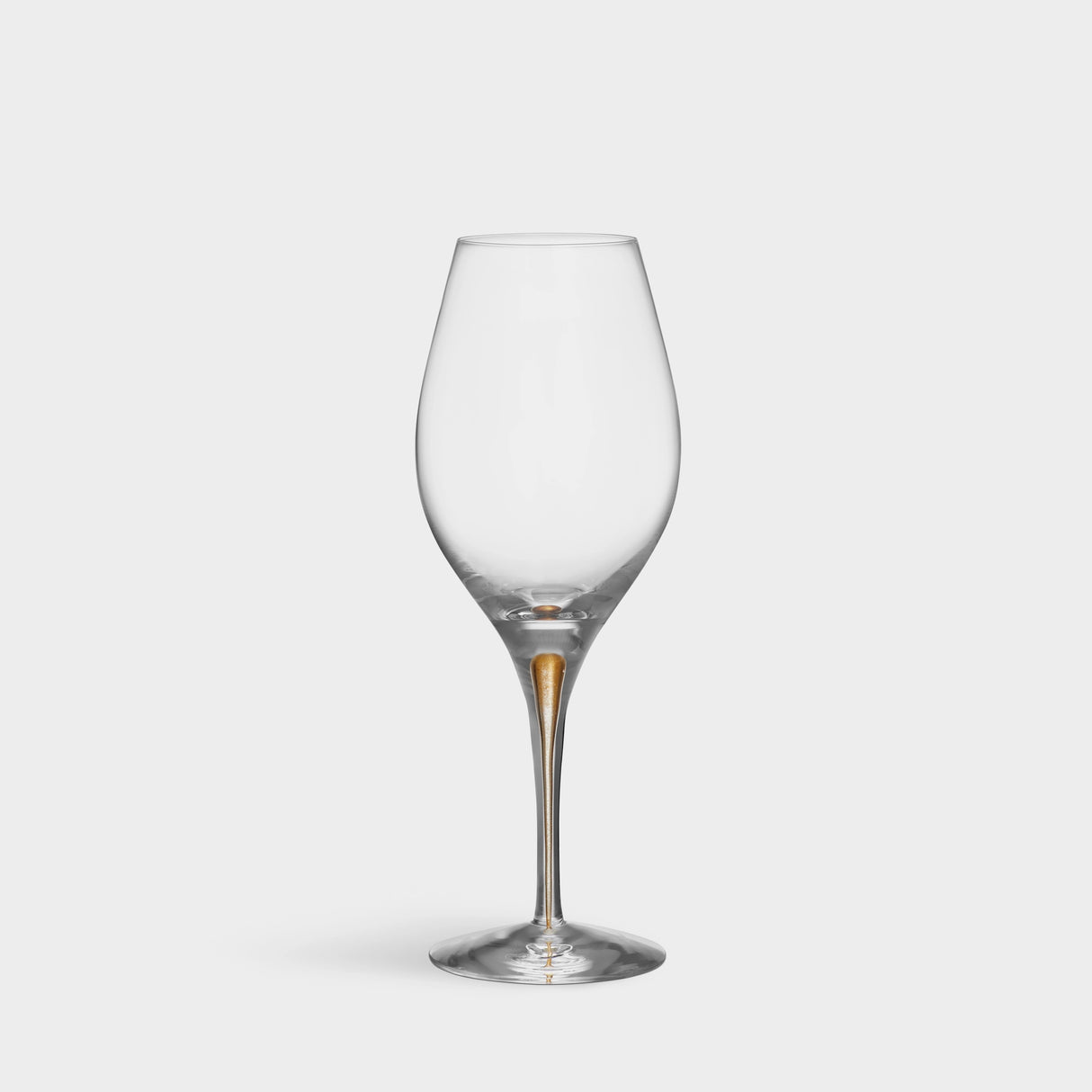 The Orrefors: Intermezzo Gold Balance Glass 14.8oz (2-Pack) features an elegant gold-tinted stem that exemplifies the series charm, enhancing any table setting against a plain white backdrop with its balanced design and craftsmanship.